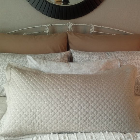 Arrangement of vibrant pillowcases in shades in creams and tans.